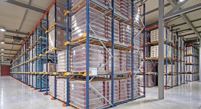 Drive-in pallet rack with forklift inside storage bay