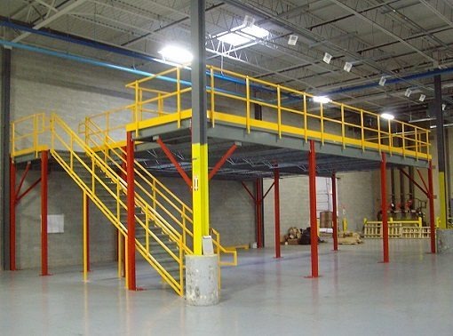 Multi-level mezzanine system with yellow stairs and red support columns