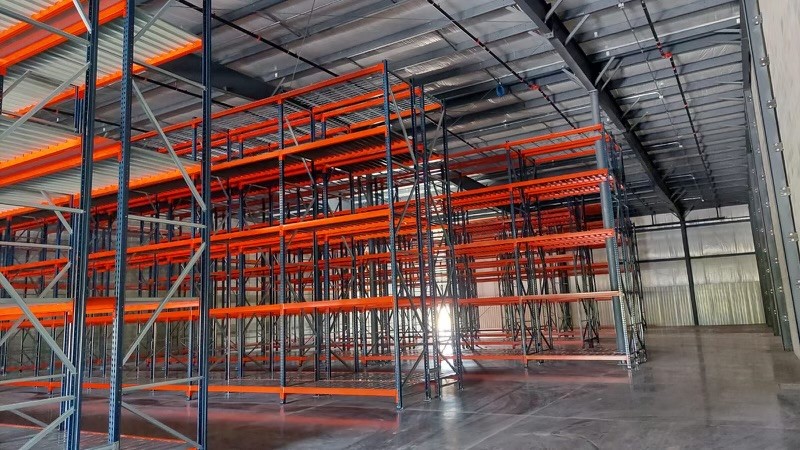 Multi-level pallet racking system with orange beams installed in Batavia OH warehouse