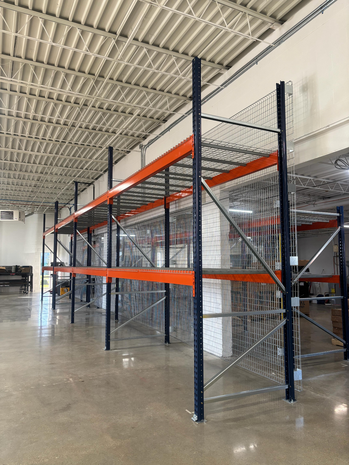 Pallet racking with rack back wire mesh panels and orange beams installed for EquipmentShare in Cincinnati OH
