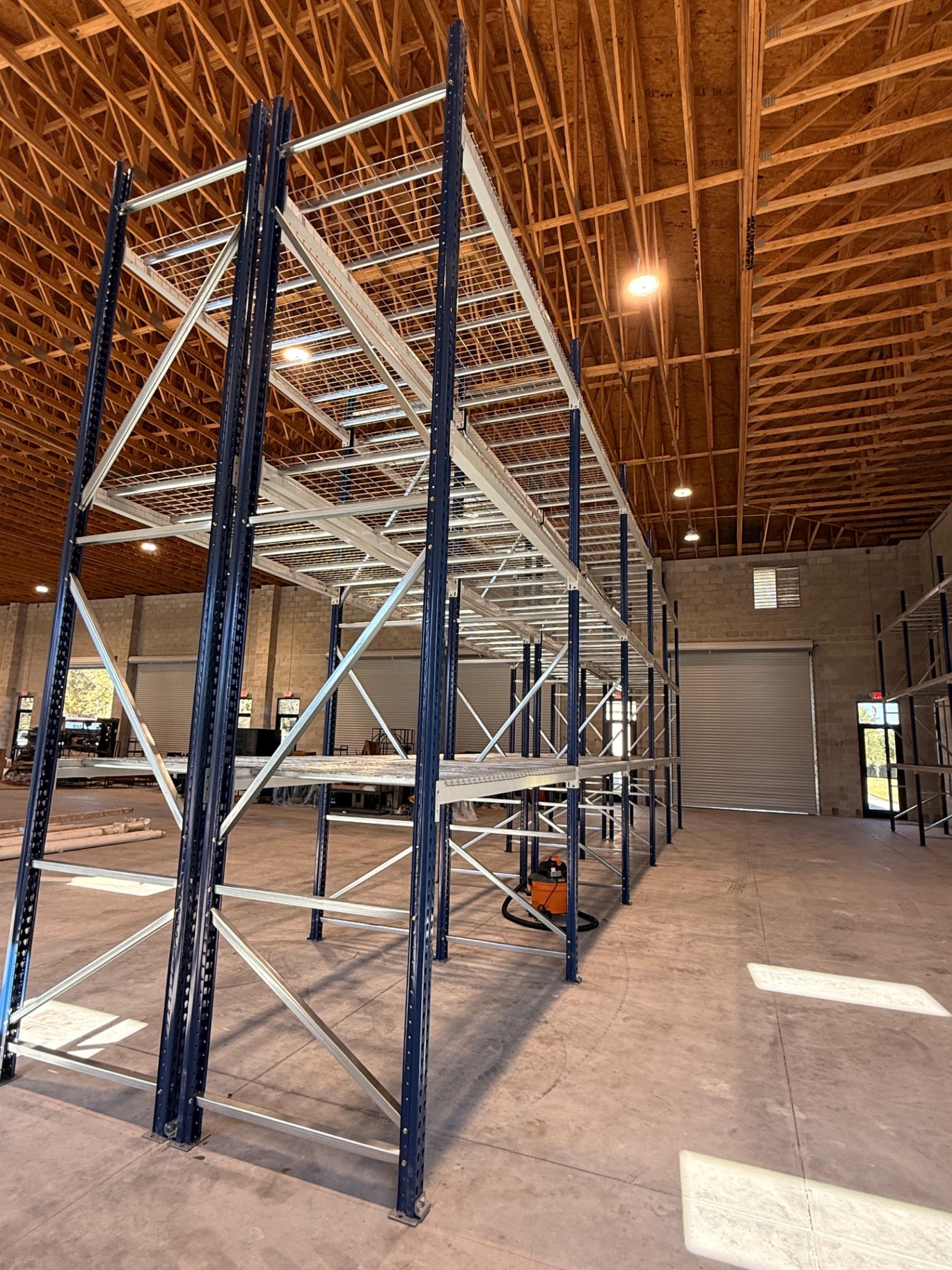 Tall pallet racking with wire decking and blue uprights installed in Lakeland FL warehouse