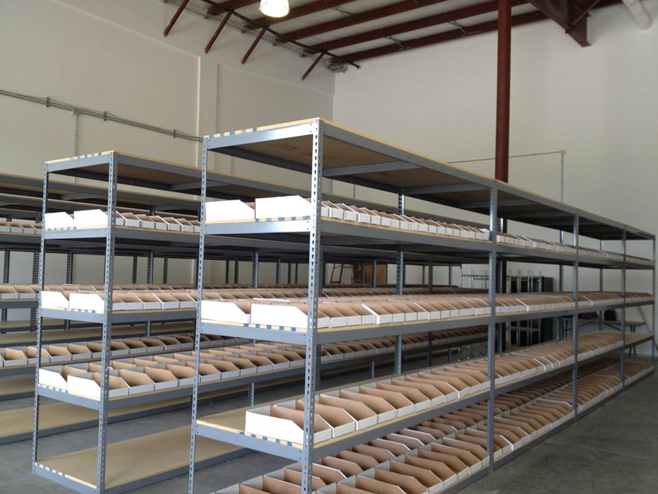 Industrial rivet shelving with carton flow systems in warehouse